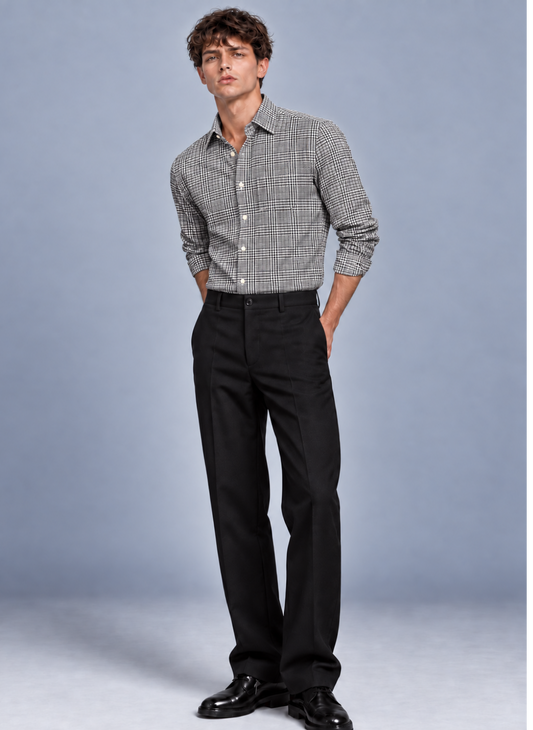 Man wearing a black Prince of Wales check dress shirt with black trousers and dress shoes.