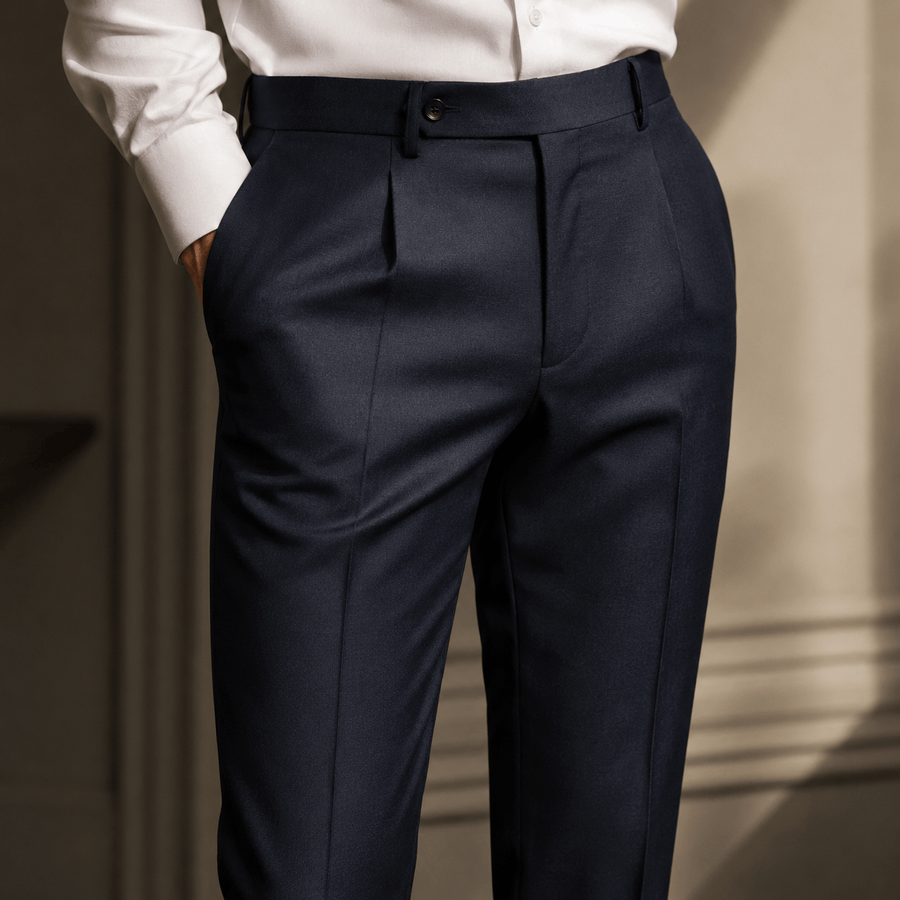 Custom tailored navy dress trousers featuring a high-waisted fit and double pleats, showcasing luxury menswear, bespoke tailoring, and premium formal pant craftsmanship.